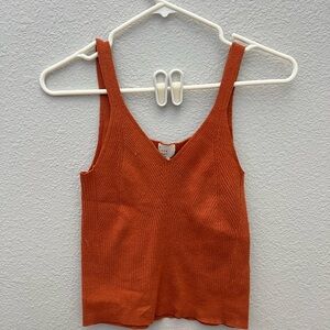 Orange cut off tank top.